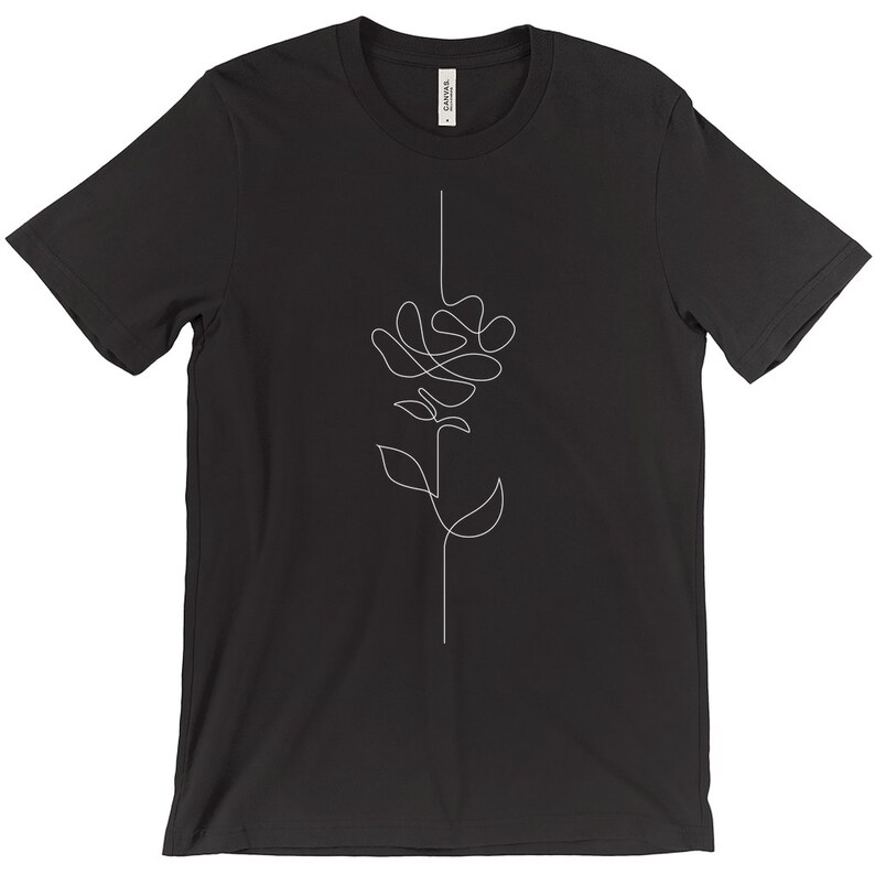 May include: Black t-shirt with a white line drawing of a rose on the front.