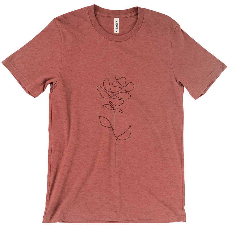 May include: A maroon t-shirt featuring a single-line drawing of a rose on the front.