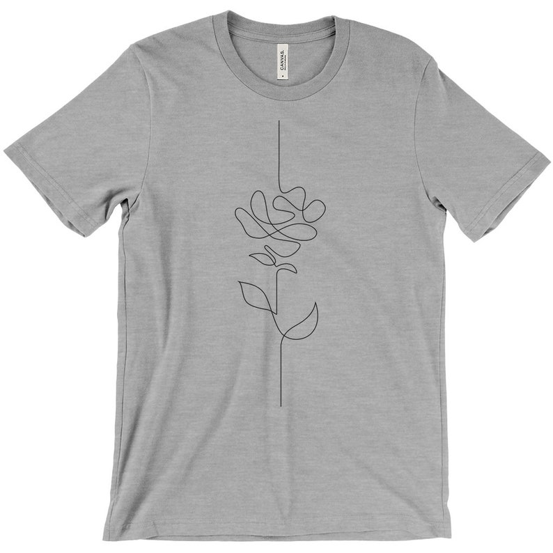 May include: A heather grey t-shirt with a single-line drawing of a flower on the front.