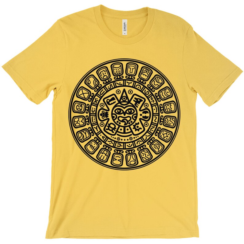 May include: A yellow t-shirt with a black graphic of the Aztec calendar. The calendar is a circular design with a central face and glyphs around the perimeter.