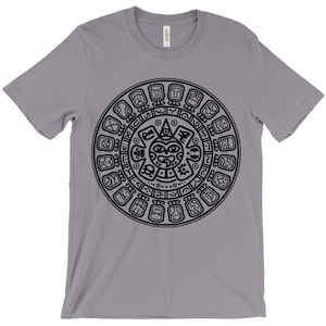 May include: A gray t-shirt with a black Aztec calendar design printed on the front.