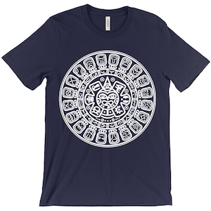 May include: A navy blue t-shirt with a white graphic of the Aztec calendar. The calendar is a circular design with a central sun face and glyphs around the perimeter.