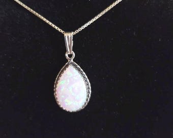 May include: A silver chain necklace with a teardrop-shaped pendant featuring a white opal gemstone.