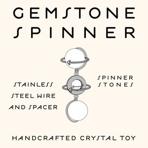 May include: A gemstone spinner with three round stones, connected by stainless steel wire and spacers. The text "Gemstone Spinner" is at the top of the image, and the text "Spinner Stones" is on the right side of the image. The text "Stainless Steel Wire and Spacer" is on the left side of the image. The text "Handcrafted Crystal Toy" is at the bottom of the image.