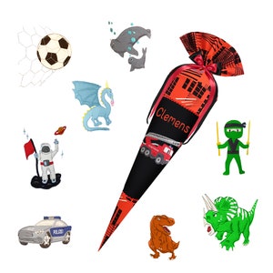 May include: A black and red school cone with the name "Clemens" printed on it. The cone is decorated with a variety of colorful illustrations, including a fire truck, a ninja, a dinosaur, a dragon, a police car, an astronaut, and a soccer ball.