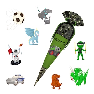 May include: A green school cone with a camouflage pattern and the name "Henrik" embroidered on it. The cone is decorated with a tractor, a ninja, a dinosaur, a dragon, a seal, a soccer ball, an astronaut, and a police car.