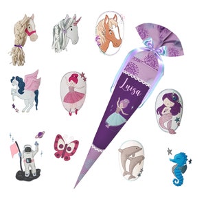 May include: A purple and white school cone with the name "Luisa" embroidered on it. The cone is decorated with a variety of colorful embroidered designs, including a mermaid, a butterfly, a unicorn, a seahorse, and a dolphin.