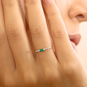 baguette cut emerald with round diamonds ring