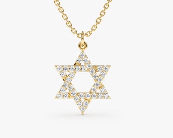 May include: A gold chain necklace with a diamond-encrusted Star of David pendant.