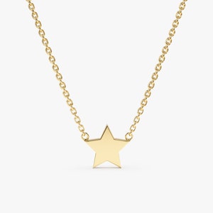 May include: A gold chain necklace with a simple star pendant.