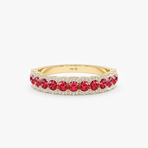 May include: A gold band ring with a row of red gemstones and a border of smaller white gemstones. The ring is marked "14K".