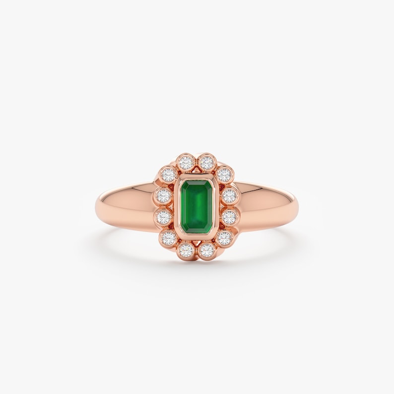 emerald ring with diamond halo in rose gold