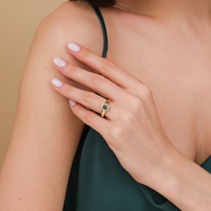 single natural emerald and diamond frame ring