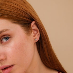Model wears Diamond Halo Stud earrings April birthstone gift for her