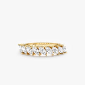 May include: A gold ring featuring a row of marquise-cut diamonds. The diamonds are set in a channel setting, and the band is a polished yellow gold. The ring is a classic and elegant design.