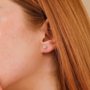 Model wears solid 14k gold diamond stud earrings
