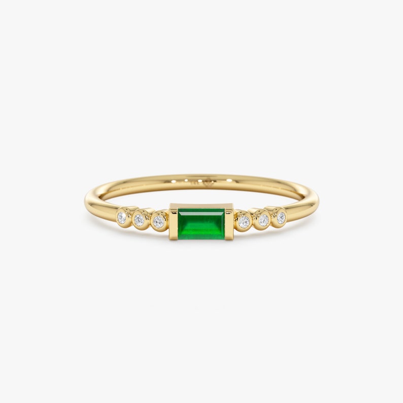 solid gold ring with emerald and diamonds