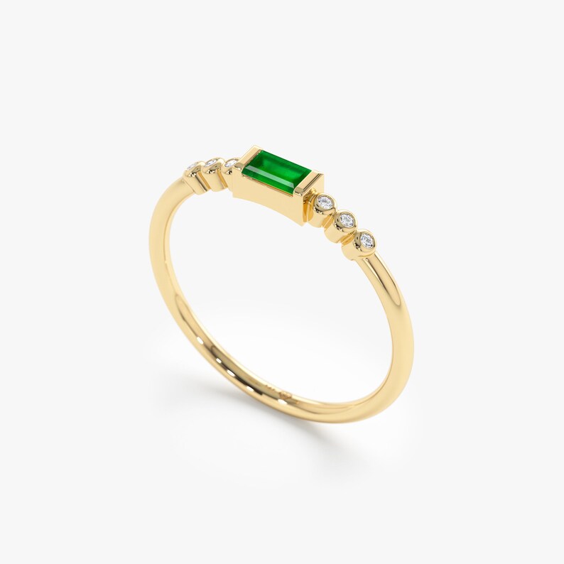 thin 14k gold ring with emerald and diamonds