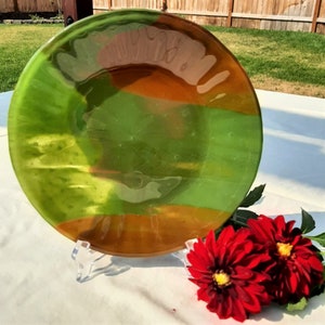 Fused glass decorative plate with scalloped edge detail. Forest green, burnt orange. RedQueenArtGlass.