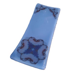 Fused glass spoon rest for kitchen. Kaleidoscope pattern image on blue glass. RedQueenArtGlass.