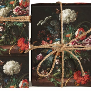 May include: A black and white floral wrapping paper with a bouquet of flowers in a vase. The paper is tied with twine and has a vintage feel.