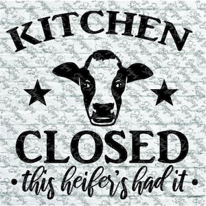 May include: Black and white sign with a cow head silhouette, two stars, and the words "KITCHEN CLOSED" above "this heifer's had it." The sign is on a white brick background.
