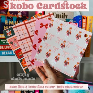 May include: A selection of decorative cardstock sheets with various patterns, including plaid, bows, and nutcracker figures. The text "Skobo Cardstock" is displayed at the top, with "crafty chels made" at the bottom.
