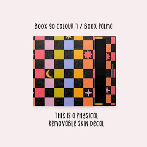 May include: A colorful skin decal for a Boox 90 Colour 7 or Boox Palma. The design features a checkerboard pattern in pink, yellow, blue, and orange squares, with celestial accents and the text "THIS IS A PHYSICAL REMOVABLE SKIN DECAL."