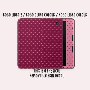 May include: A removable skin decal for Kobo Libra 2, Kobo Clara Colour, and Kobo Libra Colour e-readers. The decal has a burgundy background with small, light pink polka dots. The text "THIS IS A PHYSICAL REMOVABLE SKIN DECAL" is also visible.