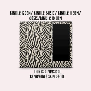 May include: A physical removable skin decal with a black and white zebra stripe pattern applied to an e-reader. Text above reads: KINDLE 12GEN/ KINDLE BASIC/ KINDLE 11 GEN/ OASIS/KINDLE 10 GEN. Text below reads: THIS IS A PHYSICAL REMOVABLE SKIN DECAL.