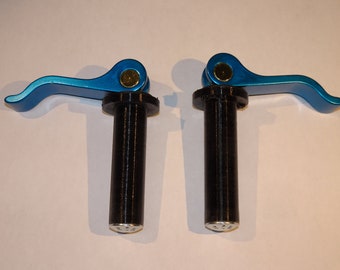 May include: Two blue metal lever clamps with black plastic handles. The levers are curved and have a gold colored screw. The handles are cylindrical and have a silver colored base.
