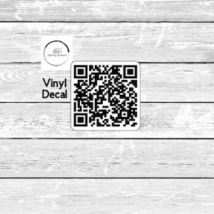 May include: A white and black vinyl decal featuring a QR code and the text "Vinyl Decal". The decal is set against a light grey wooden backdrop. A logo is in the upper left corner.