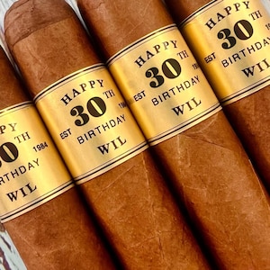 May include: Four brown cigars with gold labels that say "Happy 30th Birthday Wil Est 1984".