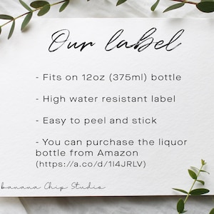 May include: A white card with the text "Our label" in elegant script. The card lists features: fits a 355ml bottle, high water resistance, and easy peel and stick. The card also mentions purchasing the liquor bottle from Amazon.