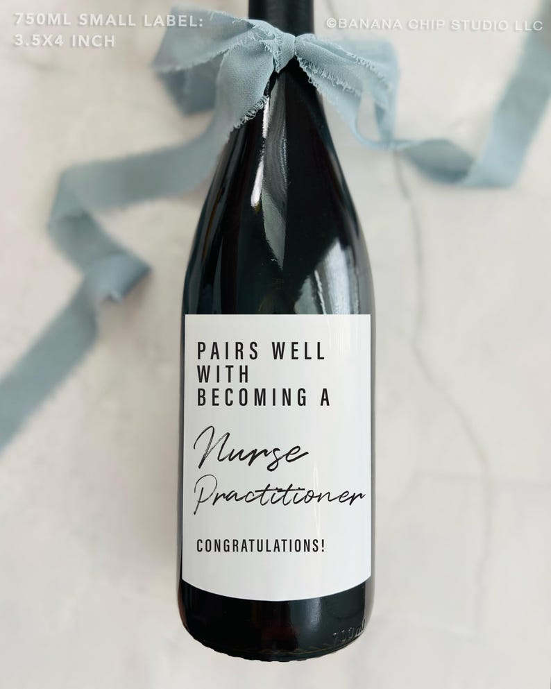 May include: A dark wine bottle with a white label that reads "Pairs Well With Becoming A Nurse Practitioner Congratulations!". The bottle is tied with a light blue ribbon. The label is 8.9x10.2 cm.