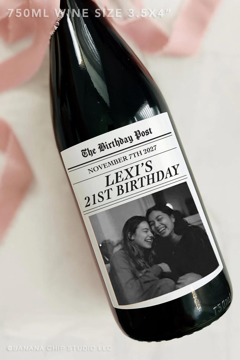 May include: A dark wine bottle with a custom label. The label reads "The Birthday Post" with "November 7th 2027" and "Lexi's 21st Birthday". A black and white photo of two smiling people is on the label. The bottle is 3.5 x 4 inches.