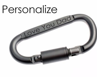 May include: A silver carabiner with a black engraved message that reads "Love You Dad".
