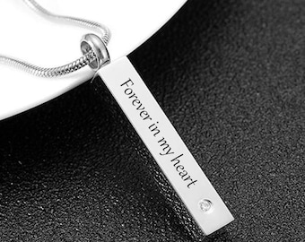 May include: Silver necklace with a rectangular pendant that reads "Forever in my heart".