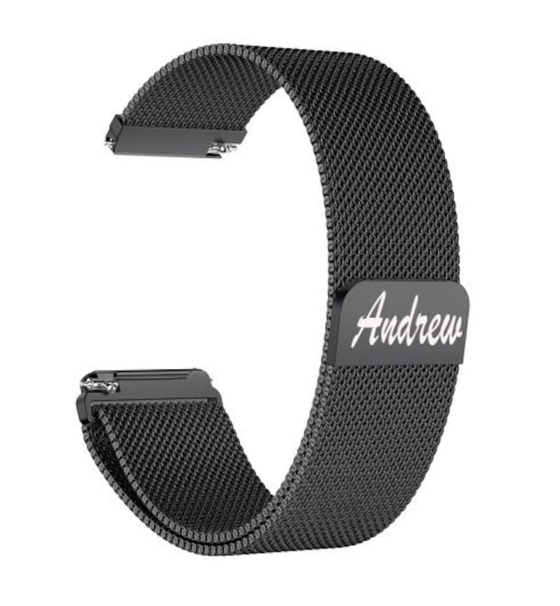 May include: A black mesh watch band with the name "Andrew" in white script. The band is made of a fine, woven material and has a magnetic clasp. The band is designed to fit a smartwatch or similar device.