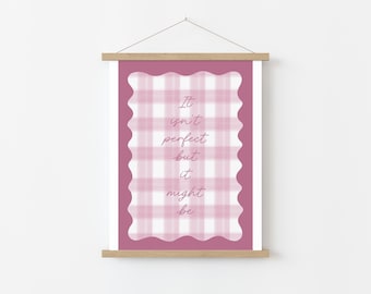 May include: A framed print with a pink and white gingham pattern and the quote "It isn't perfect but it might be" in a script font. The print is displayed on a wooden hanger.