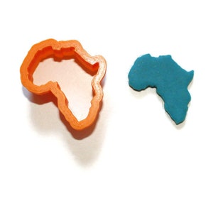 May include: An orange plastic cookie cutter shaped like the continent of Africa, next to a blue playdough cutout of the continent of Africa.