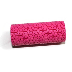 May include: A pink foam roller with a diamond pattern. The roller is designed for muscle recovery and stretching.