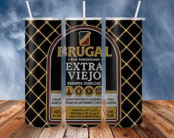 May include: A cylindrical tumbler with a straw featuring a black background with a gold diamond grid pattern. The design displays the Brugal Extra Viejo rum label with text including Ron Dominicano, Reserva Familiar, 40% Alc/Vol, and 750ml.