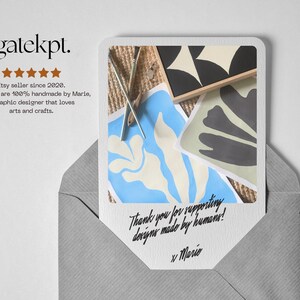 May include: A greeting card with abstract art prints in a gray envelope. The card features a blue and white floral design, a black and white geometric design, and a gray floral design. Text on the card reads "Thank you for supporting designs made by humans!"