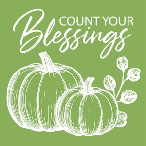 May include: A green background with white text that reads "Count Your Blessings". Two white pumpkins and a sprig of leaves are also featured in the image. The pumpkins are detailed with lines.