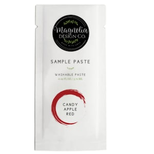 May include: A white packet of "Candy Apple Red" sample paste from Magnolia Design Co. The packet includes the text "Sample Paste" and "Washable Paste". The packet contains 0.19 fl oz / 5.7 ml of paste.