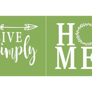 May include: Two green rectangular signs with white text. The left sign says "LIVE simply" with an arrow. The right sign says "HOME" with a wreath in place of the "O". Home decor.