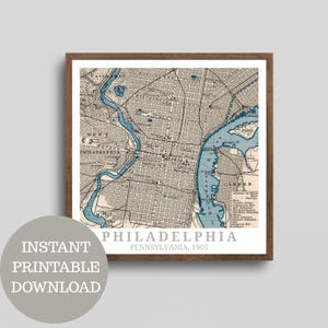 May include: Framed vintage map print of Philadelphia, Pennsylvania, from 1905. The map features a detailed street layout in gray and white, with blue highlighting the rivers and waterways. The print is in a brown wooden frame, with the words "Philadelphia" and "Pennsylvania, 1905" printed on the bottom.