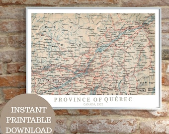 May include: A framed vintage map print of the Province of Québec, Canada, from 1922. The map shows a detailed grid with roads and place names in black and blue on a beige background. The text "Province of Québec" and "Canada, 1922" are visible.