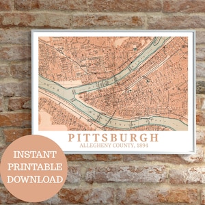 May include: A framed vintage map of Pittsburgh, Allegheny County, from 1894. The map features a detailed illustration of the city with blue rivers and a peach-coloured background. The words "Pittsburgh" and "Instant Printable Download" are visible.